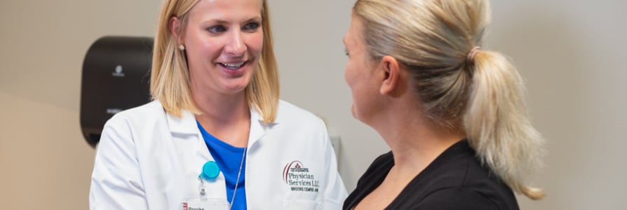 Gastroenterology provider, Brooke Cemper, APRN, talking to a patient.