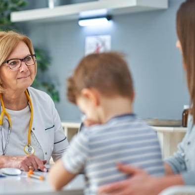 Medical professional examining a child.