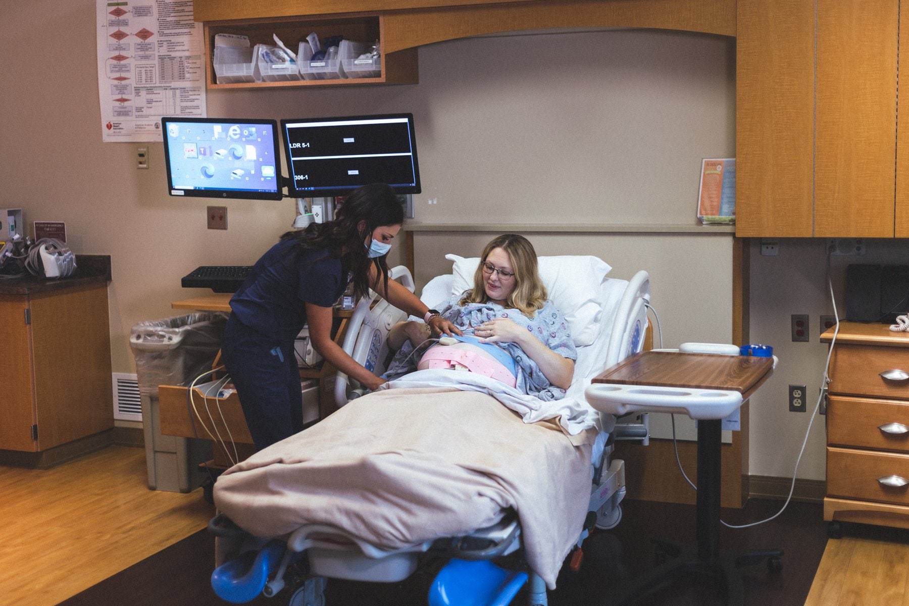 An obstetrics nurse caring for a mom and her new baby.