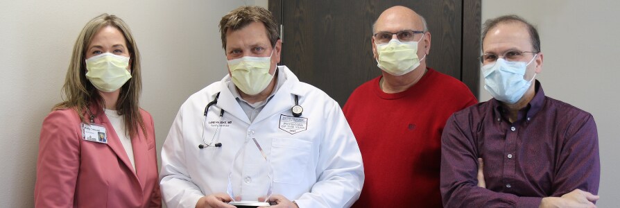 Dr. Lane Handke with his 2021 Physician of the Year award.