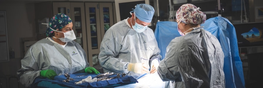 General surgeon, Dr. Nicholas Boyle, examining a patient.