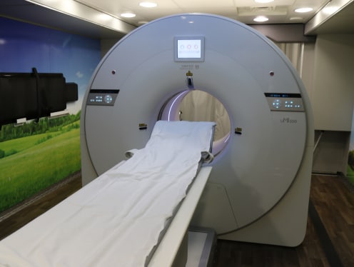 A CT Scan Tech performing a CT scan on a patient.