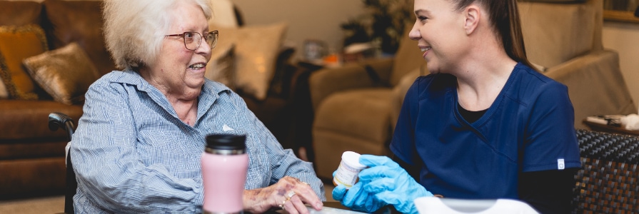 A home health nurse taking care of a patient.