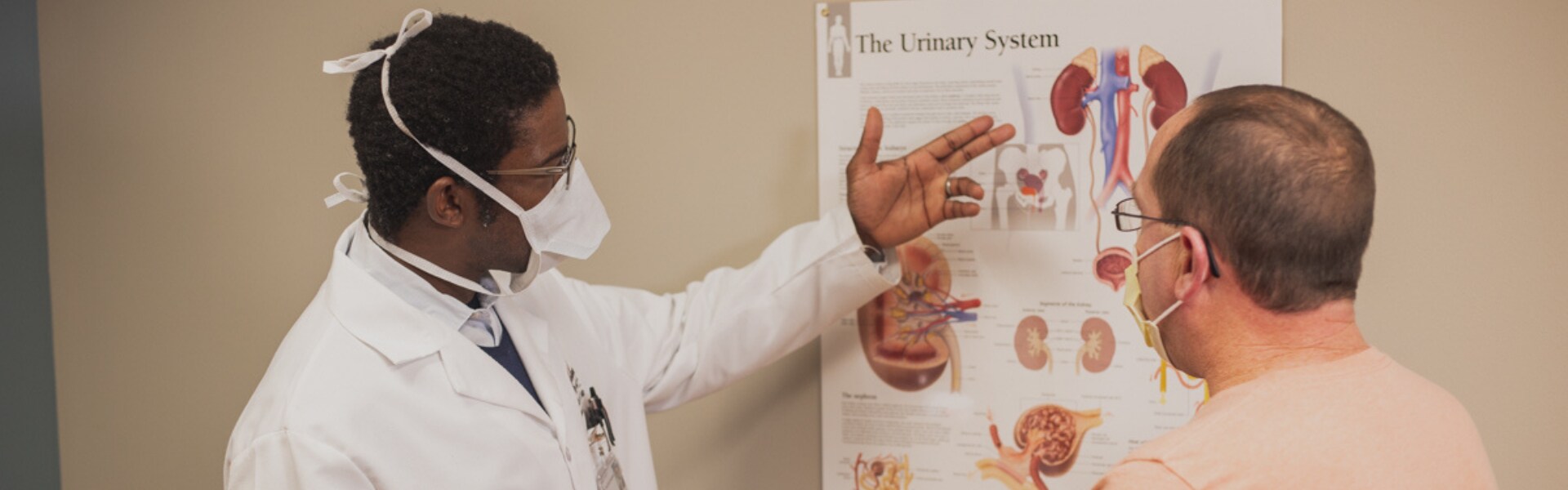 Dr. Yemi, a urologist, speaking to a patient.