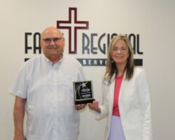 Dr. Mark Davis, Chief Medical Officer, and Kelly Driscoll, CEO, with the LifeBridge award.