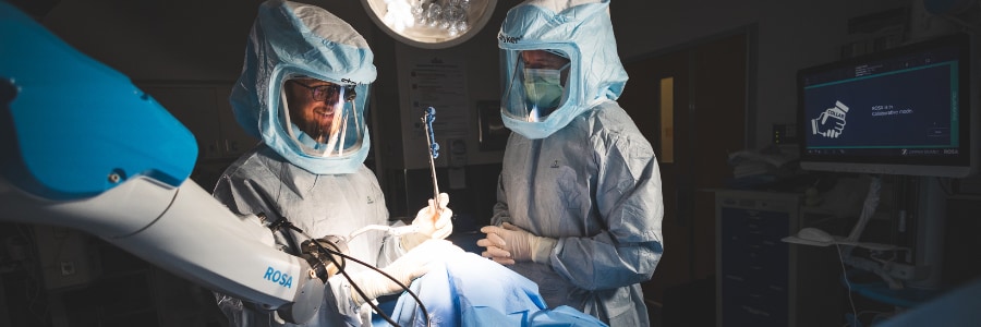 Orthopedic surgeons performing a knee surgery using robot-assisted technology.