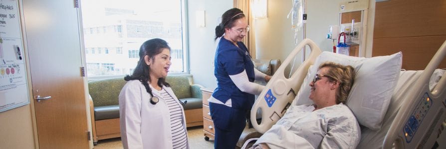 Dr. Manisha Koirala, a hospitalist, talking to a patient.