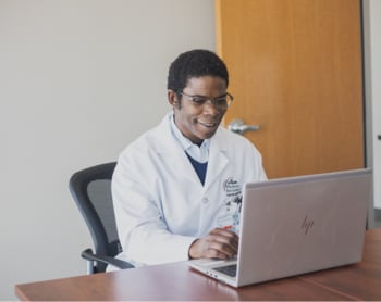 Dr. Yemi, a urologist, speaking to a patient.