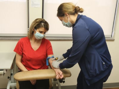 An occupational medicine nurse performing an employee blood test.