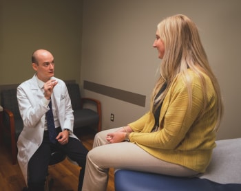 General surgeon, Dr. Nicholas Boyle, talking to a patient.