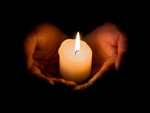 A candle burning in memory of a loved one.