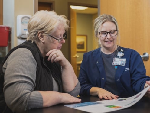 A cancer nurse navigator talking to a patient.