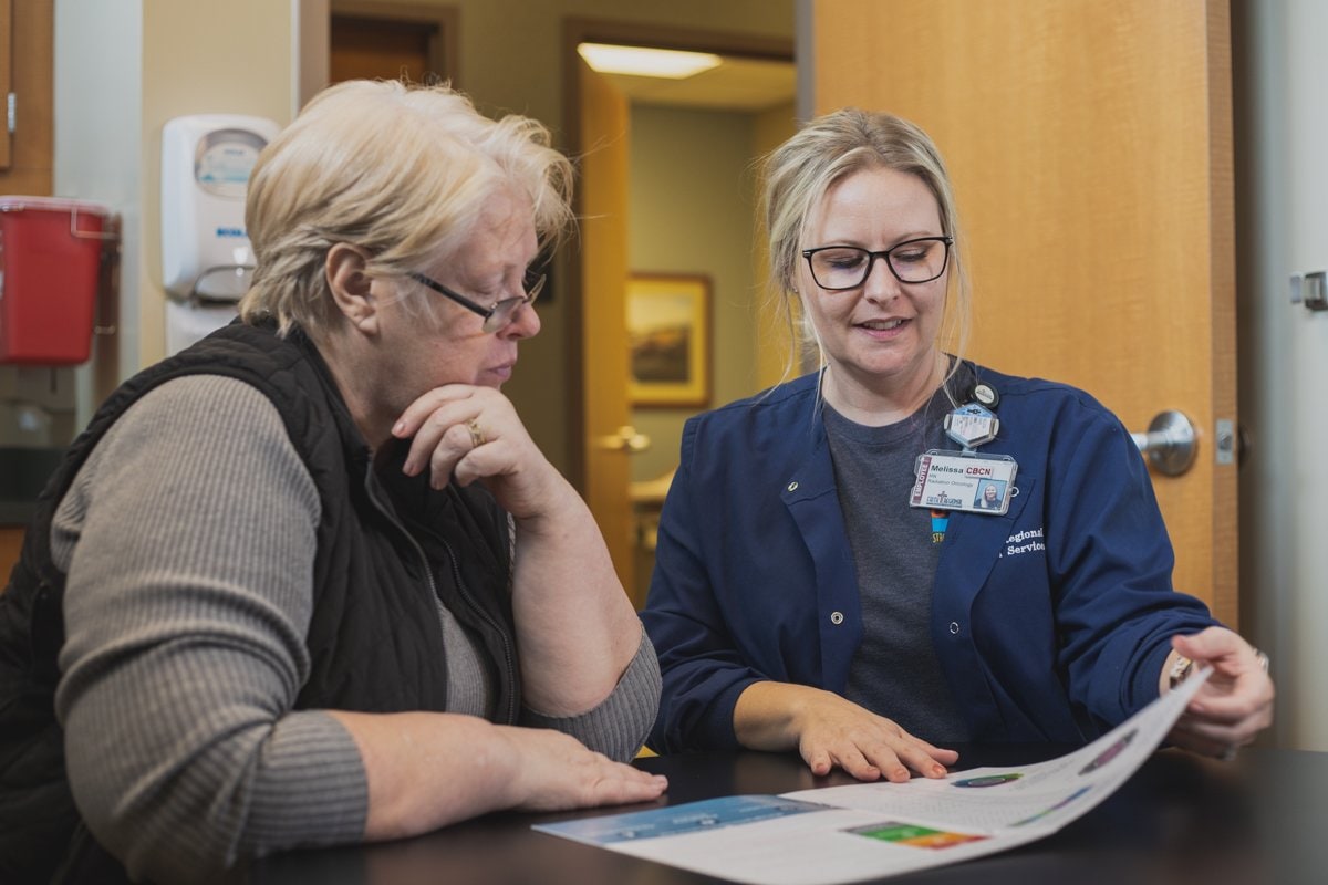 Patient navigator speaking with a patient.