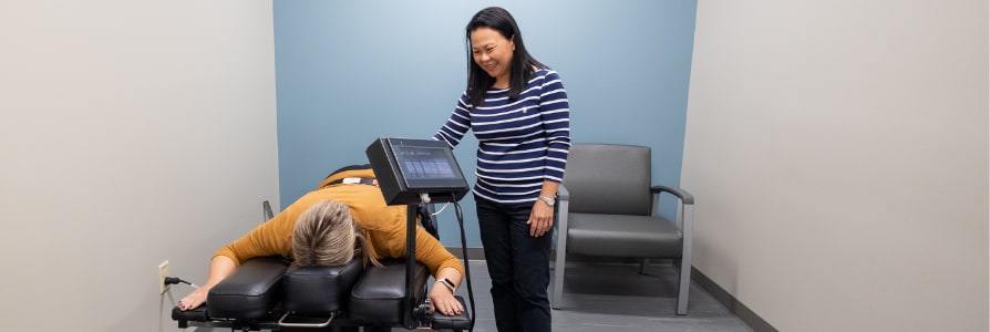 Physical therapist, Lin Pu, working with a patient.