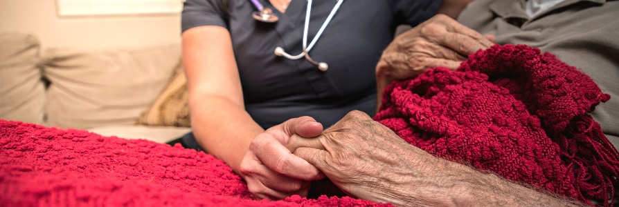 A hospice nurse caring for a hospice patient at home.