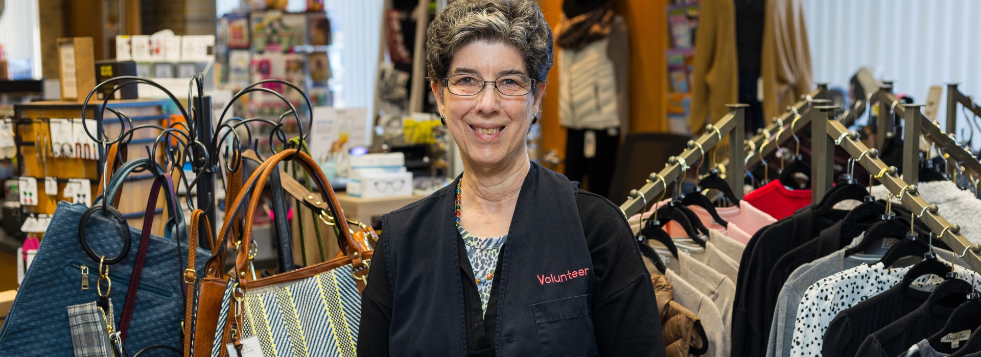 Volunteer standing at guest services desk