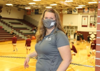 Maria Beck, an athletic trainer, on the sidelines of a high school basketball game.