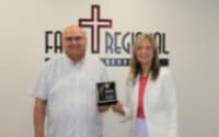 Dr. Mark Davis, Chief Medical Officer, and Kelly Driscoll, CEO, with the LifeBridge award.