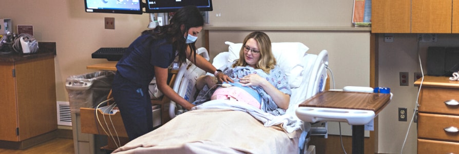 A labor and delivery nurse taking care of a mom in labor.