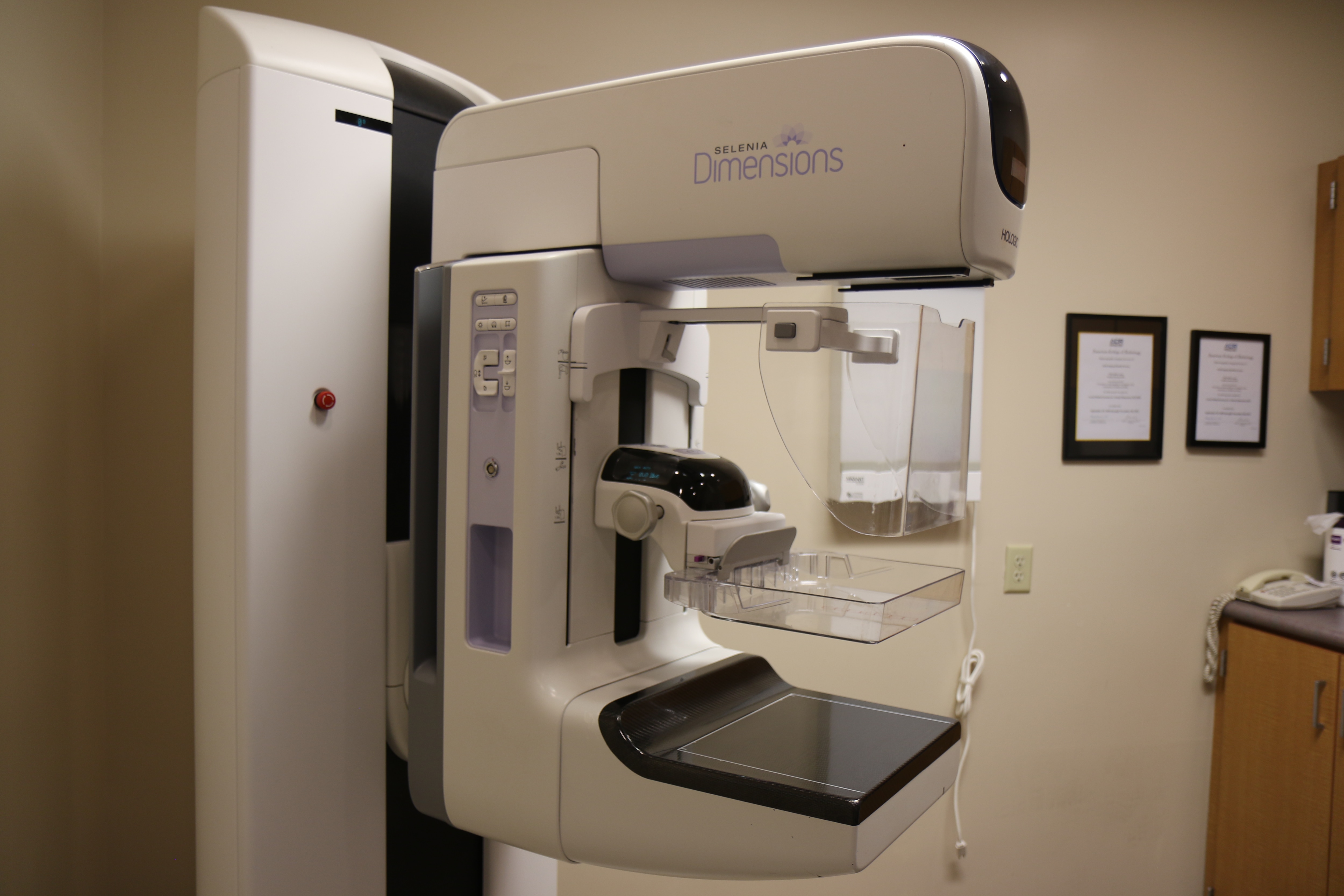 An employee with a mammography machine.