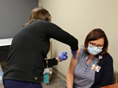 An occupational medicine nurse performing an employee flu shot.