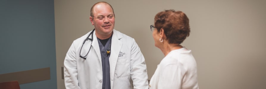 Dr. Enrique Moreno, a vascular surgeon, speaking to a patient.