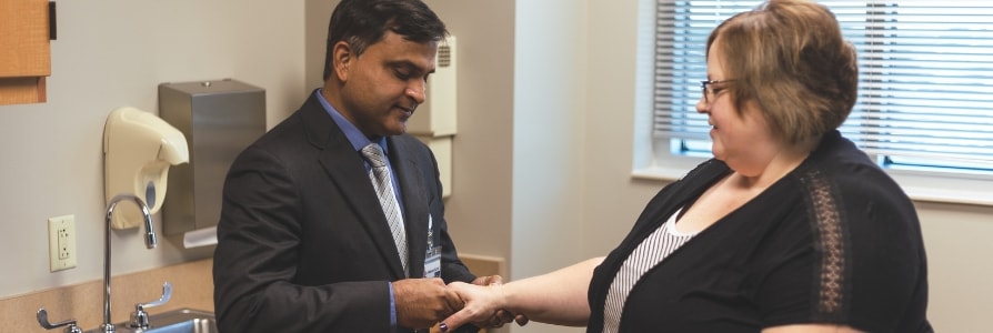 Dr. Kumar, a rheumatologist, checking a patient's hand.