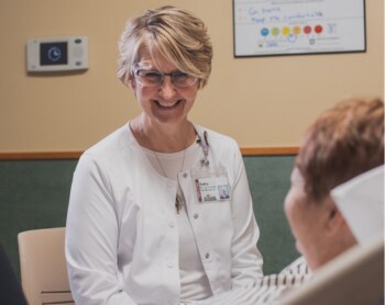 A nurse navigator speaking to a knee replacement patient.