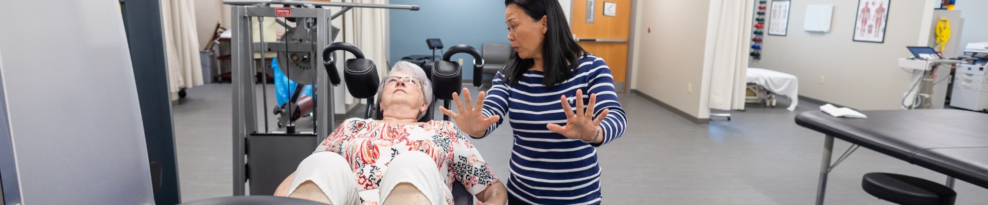 Provider helping patient through physical therapy 